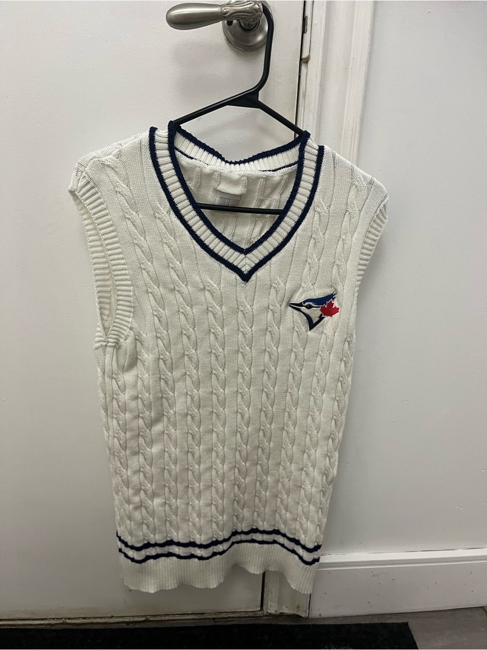 White Cable Knit Sleeveless Sweater Vest with Navy Trim and Blue Jay Patch